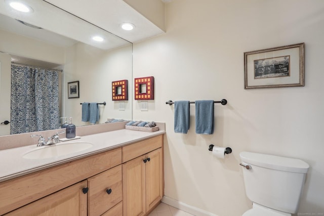 bathroom featuring tile patterned flooring, vanity, and toilet