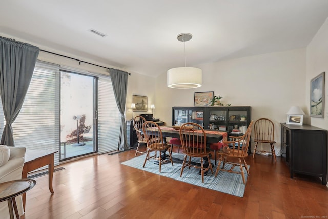 dining space featuring wood-type flooring