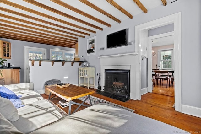 living room with beam ceiling and hardwood / wood-style floors