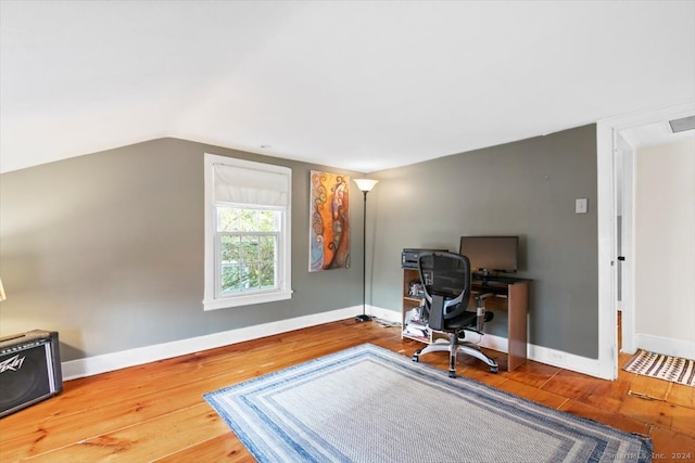 office featuring hardwood / wood-style floors and lofted ceiling