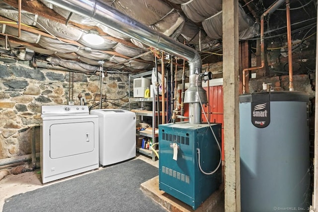 basement featuring washing machine and dryer and water heater