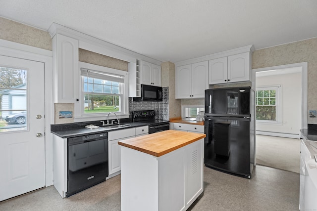 kitchen with sink, white cabinetry, plenty of natural light, and black appliances