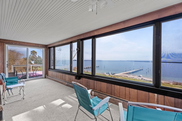 unfurnished sunroom with a water view