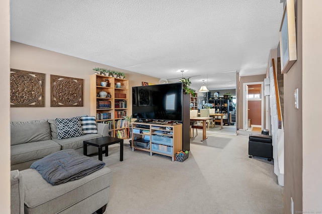 carpeted living room featuring a textured ceiling