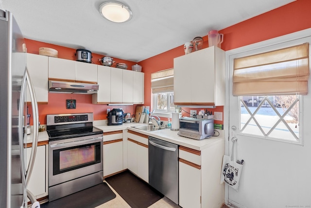 kitchen with white cabinetry, appliances with stainless steel finishes, and sink