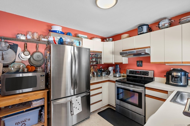 kitchen featuring stainless steel appliances, sink, and white cabinets