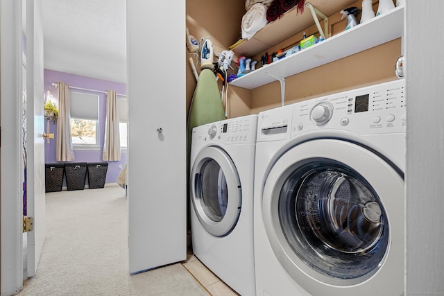 laundry room featuring light carpet and washer and dryer