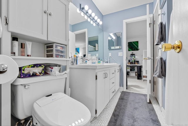 bathroom with tile patterned floors, vanity, and toilet