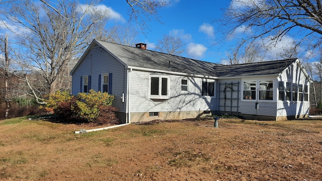 view of property exterior with a lawn and a sunroom