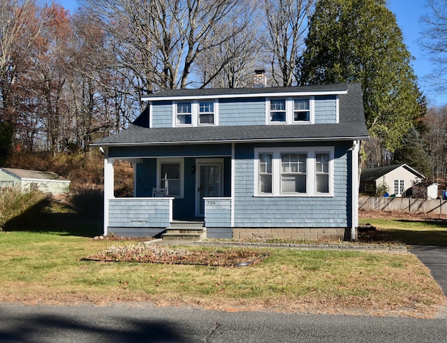 front of property featuring covered porch and a front yard