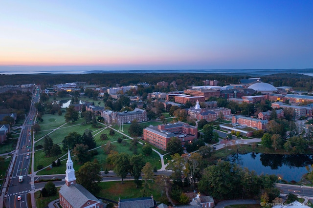 aerial view at dusk with a water view