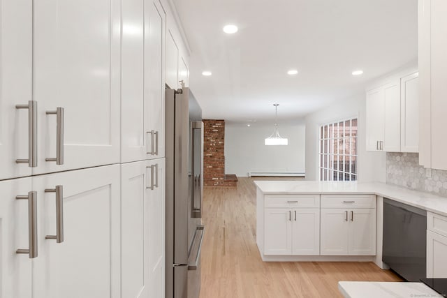 kitchen featuring stainless steel fridge, light hardwood / wood-style flooring, white cabinetry, and decorative light fixtures