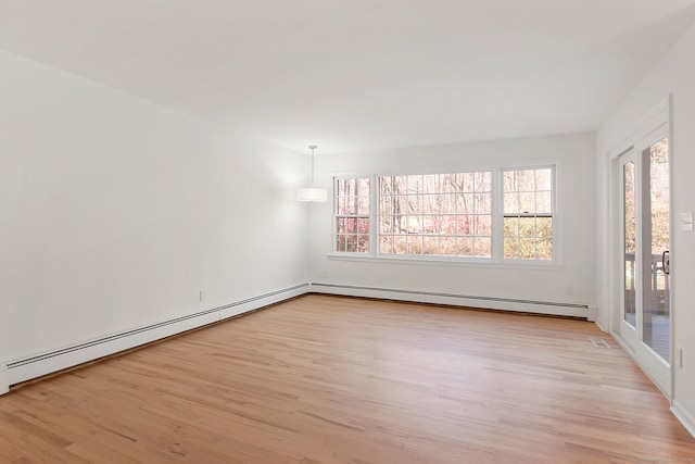 empty room with a baseboard heating unit and light wood-type flooring