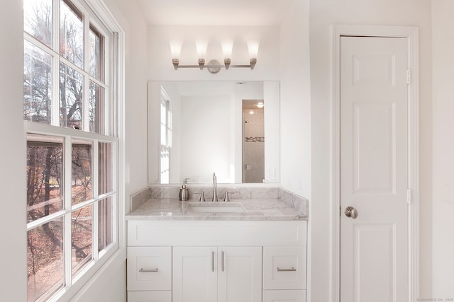 bathroom with vanity and a healthy amount of sunlight