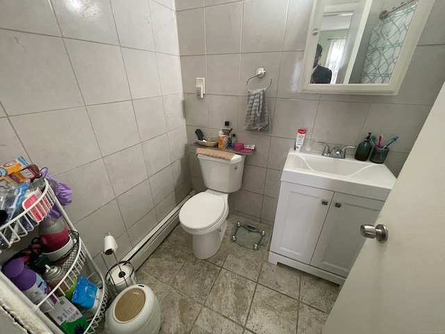 bathroom with toilet, vanity, backsplash, and tile walls