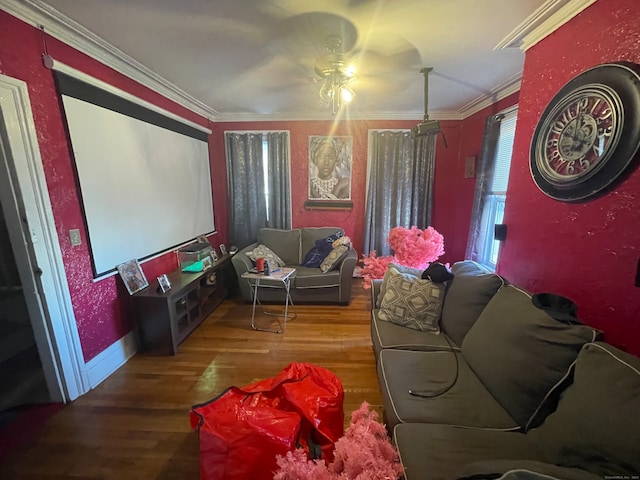 home theater with hardwood / wood-style flooring, ceiling fan, and crown molding