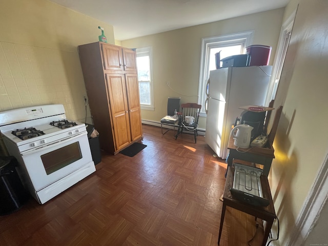 kitchen with white appliances and dark parquet flooring