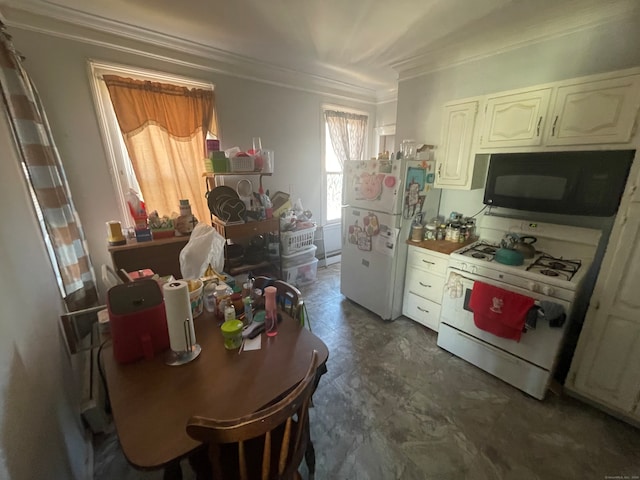 kitchen with ornamental molding and white appliances