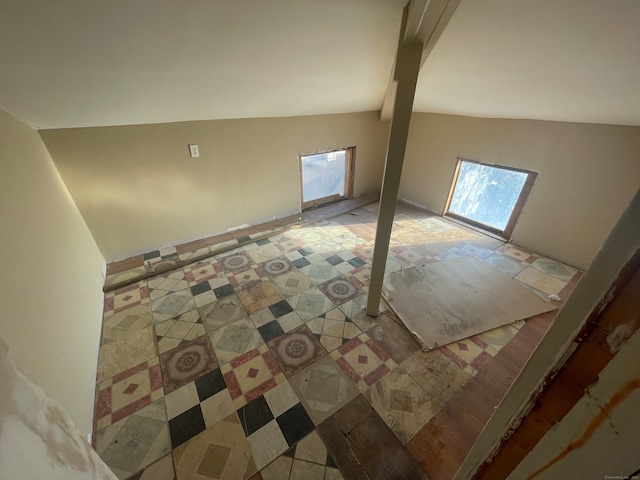 bonus room with vaulted ceiling with beams