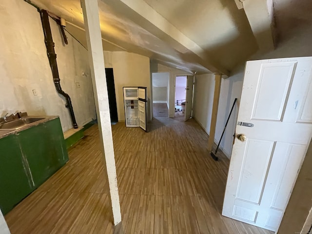 bonus room with hardwood / wood-style flooring, sink, and vaulted ceiling