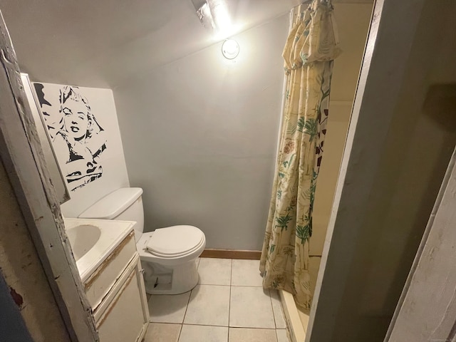 bathroom with tile patterned flooring, curtained shower, vanity, and toilet