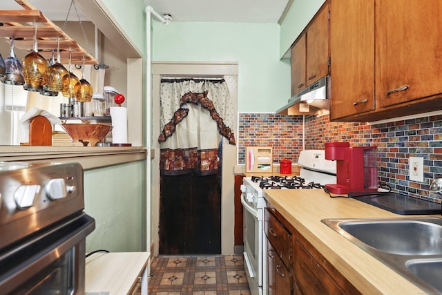 45 Ives St, Waterbury, CT 06704 - kitchen with white gas stove, stove, tasteful backsplash, dark flooring, and brown cabinets