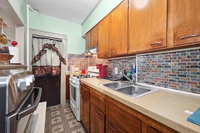 45 Ives St, Waterbury, CT 06704 - kitchen with white gas range oven, under cabinet range hood, light countertops, light floors, and brown cabinets