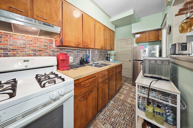 45 Ives St, Waterbury, CT 06704 - kitchen with white gas stove, under cabinet range hood, light countertops, refrigerator, and backsplash