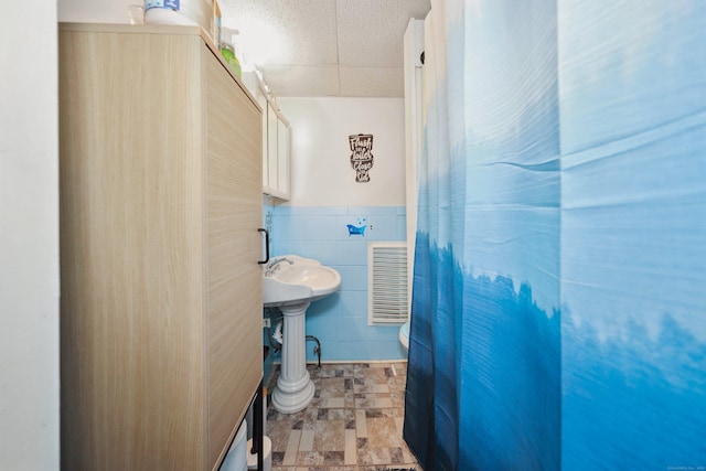 45 Ives St, Waterbury, CT 06704 - bathroom with stone finish flooring, tile walls, and a wainscoted wall