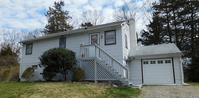 view of front of house featuring a garage and a front lawn