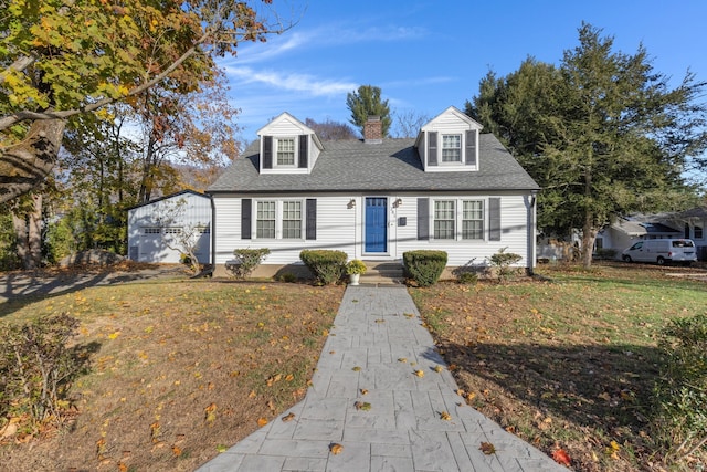 cape cod-style house with a garage and a front lawn