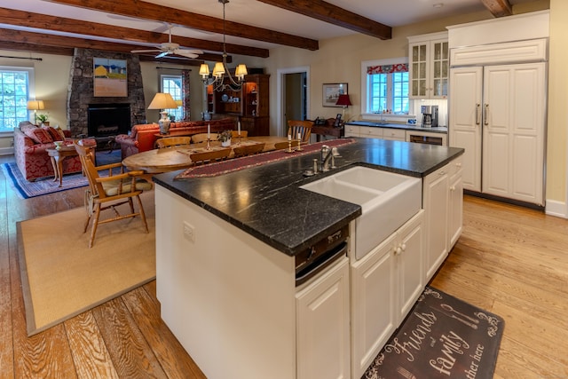 kitchen with a sink, plenty of natural light, and light wood-style flooring
