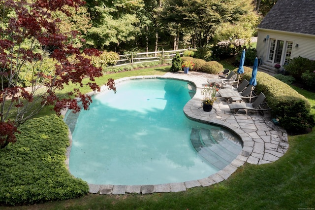 view of pool with french doors and a patio