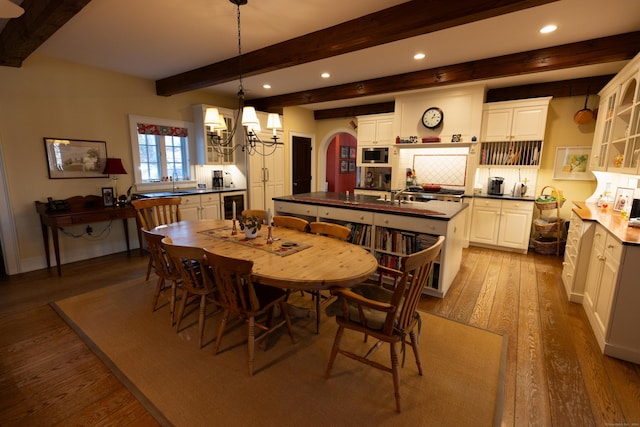 dining area with wine cooler, wood finished floors, beamed ceiling, recessed lighting, and a notable chandelier