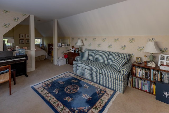 living room featuring carpet floors, wallpapered walls, and vaulted ceiling