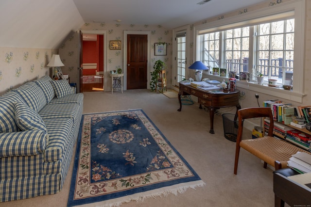 carpeted living area featuring vaulted ceiling, wallpapered walls, and visible vents
