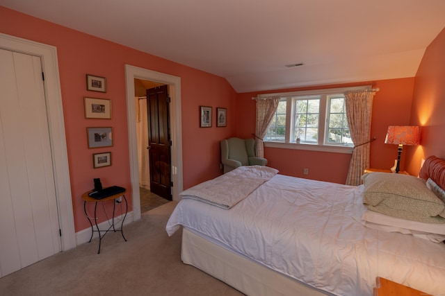 bedroom featuring visible vents, carpet flooring, and lofted ceiling