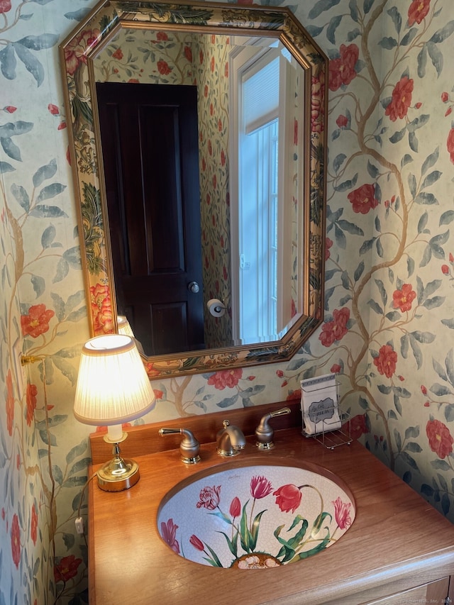 interior space featuring wallpapered walls and a sink