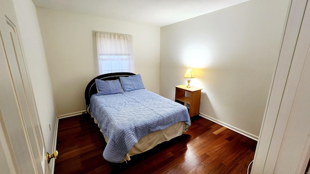 bedroom featuring dark hardwood / wood-style flooring