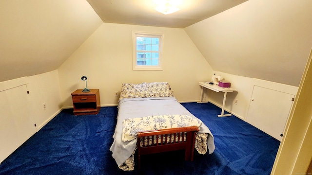 carpeted bedroom featuring lofted ceiling