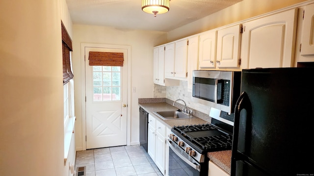 kitchen with sink, white cabinetry, stainless steel appliances, and tasteful backsplash