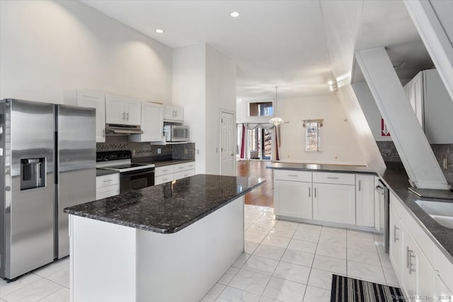 kitchen featuring a kitchen island, pendant lighting, white cabinets, and stainless steel appliances