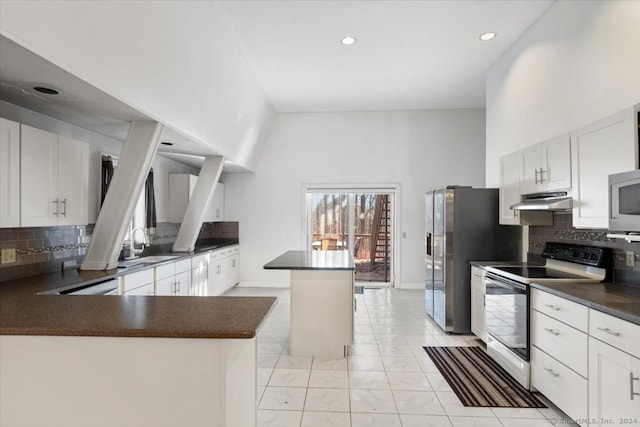 kitchen with white cabinetry, sink, appliances with stainless steel finishes, backsplash, and a center island