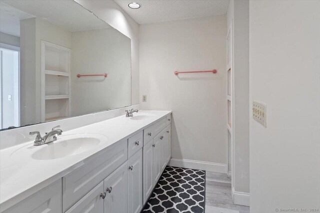 bathroom with hardwood / wood-style flooring and vanity