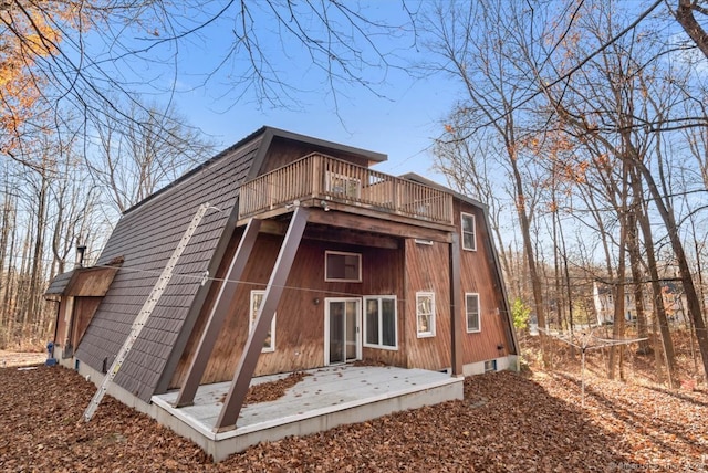 rear view of property with a wooden deck