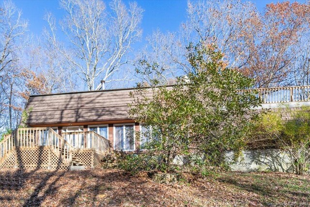 back of property with a wooden deck