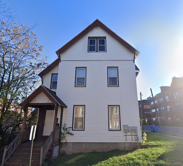 rear view of property with a yard