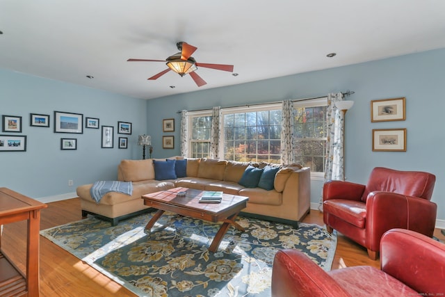 living room with hardwood / wood-style floors and ceiling fan