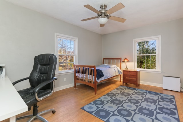 bedroom featuring ceiling fan and hardwood / wood-style flooring