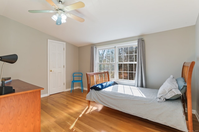 bedroom featuring hardwood / wood-style floors, ceiling fan, and lofted ceiling